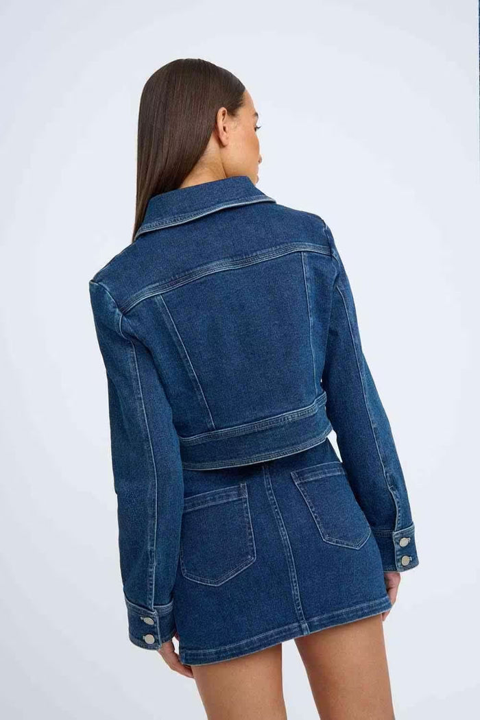 Woman wearing an indigo denim crop jacket from BY JOHNNY, back view, styled for spring layering