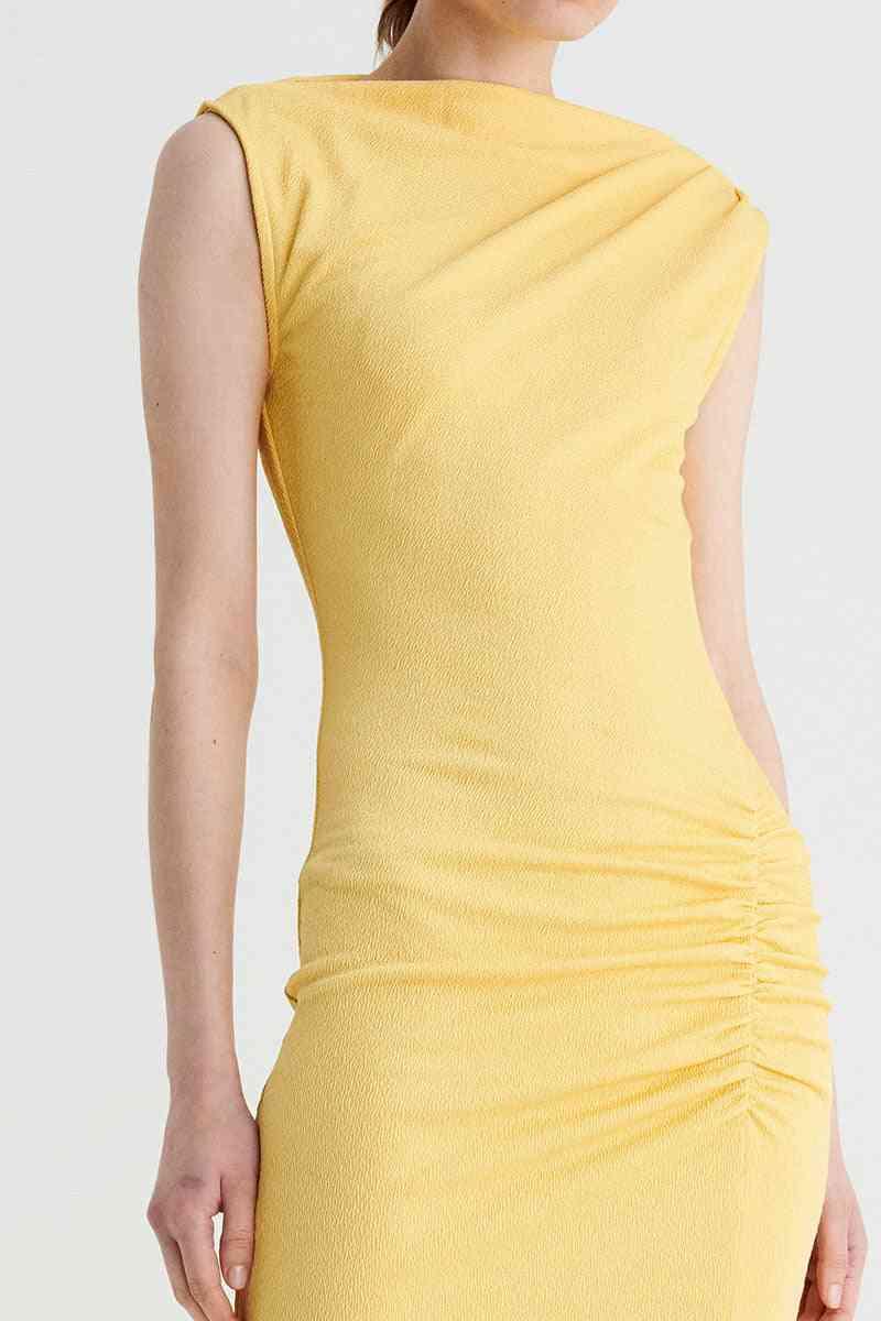 a woman is wearing a yellow Suboo Vega Rouched Front Midi Dress in Butter