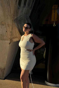 Thumbnail for a woman in a Suboo Jacqui Twist Front Mini Dress posing for a picture