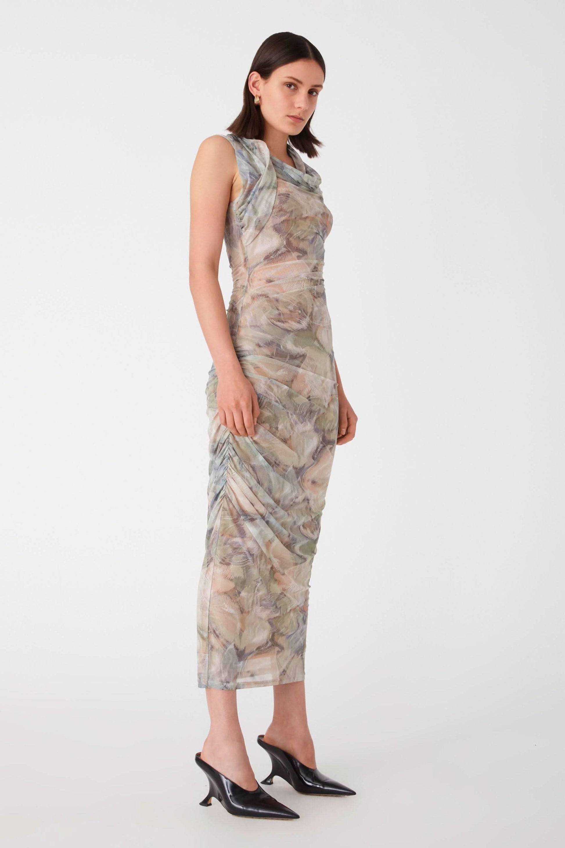 a woman wearing a Misha Collection Breslin Mesh Midi Dress with a floral print