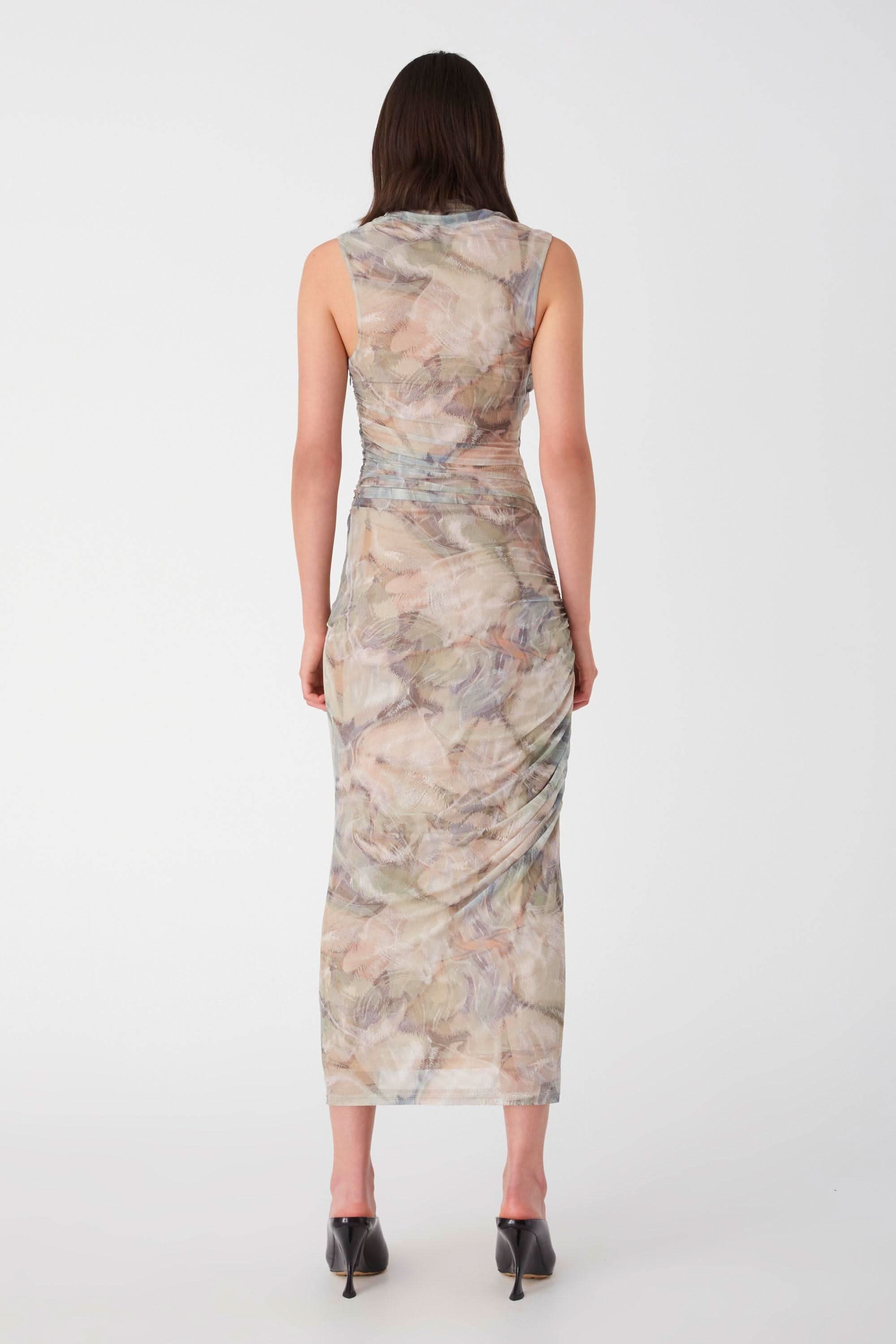 a woman wearing a Misha Collection Breslin Mesh Midi Dress with a floral print