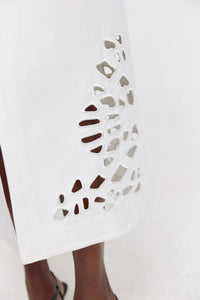 Thumbnail for a close up of a person's legs wearing a white dress