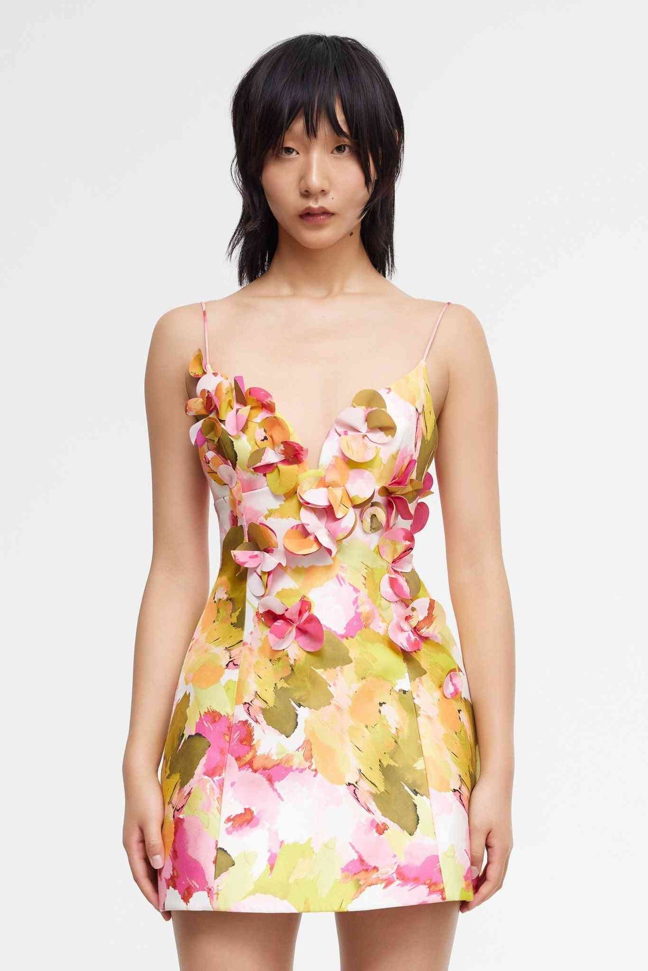 a woman in a Acler Isla Mini Dress with flowers on it