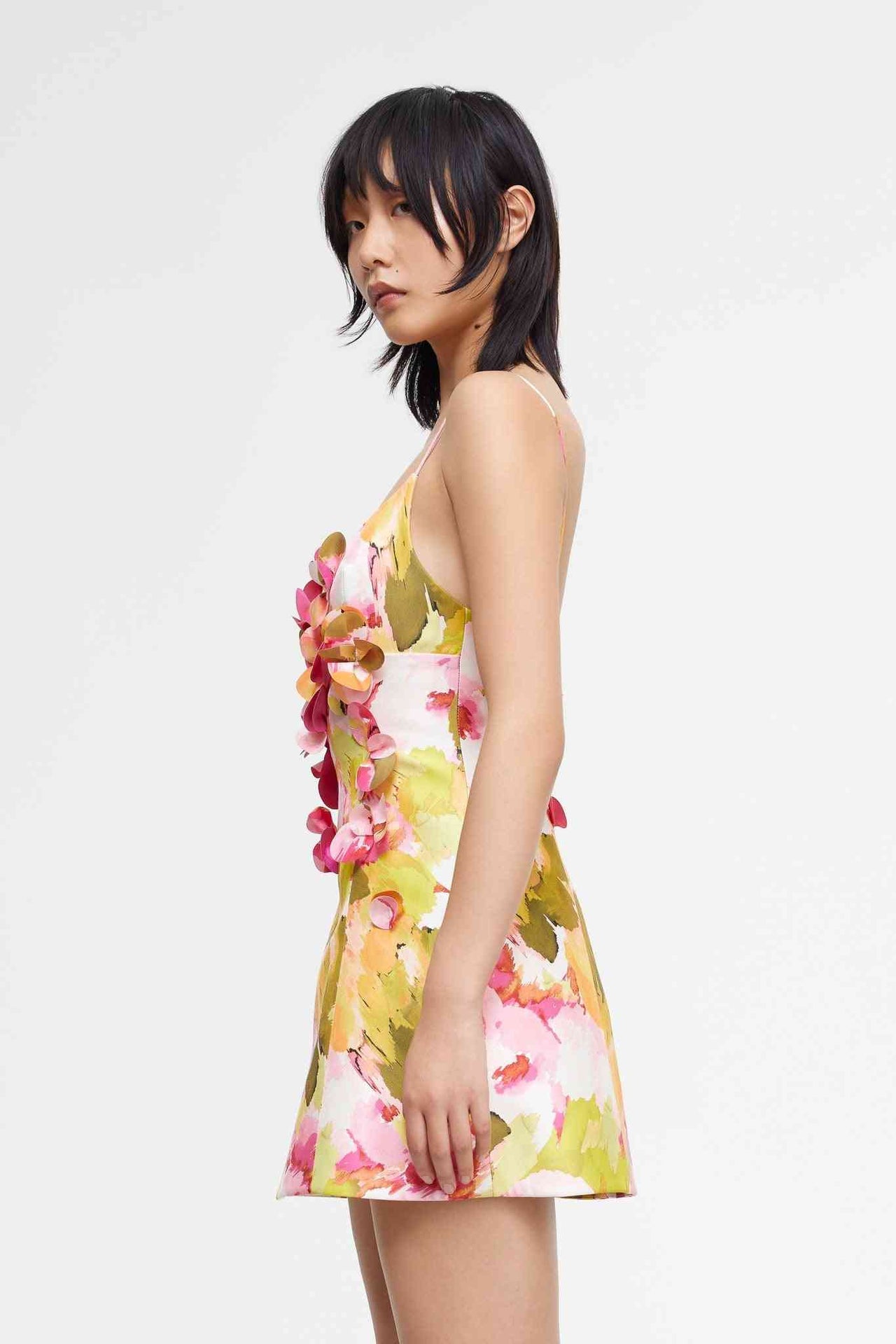 a woman in a floral Acler Isla Mini Dress poses for a picture