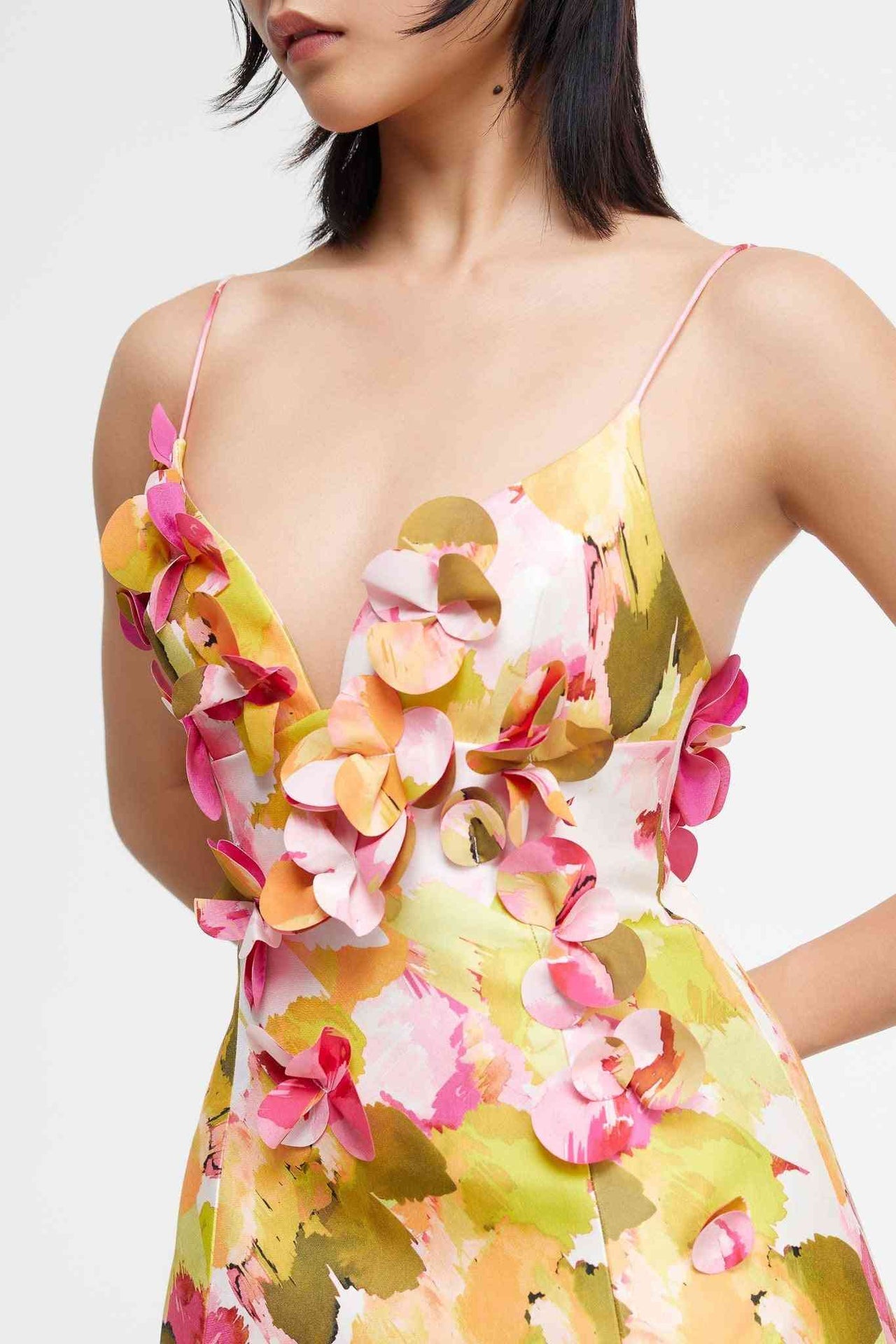 a woman in a Acler Isla Mini Dress with flowers on it