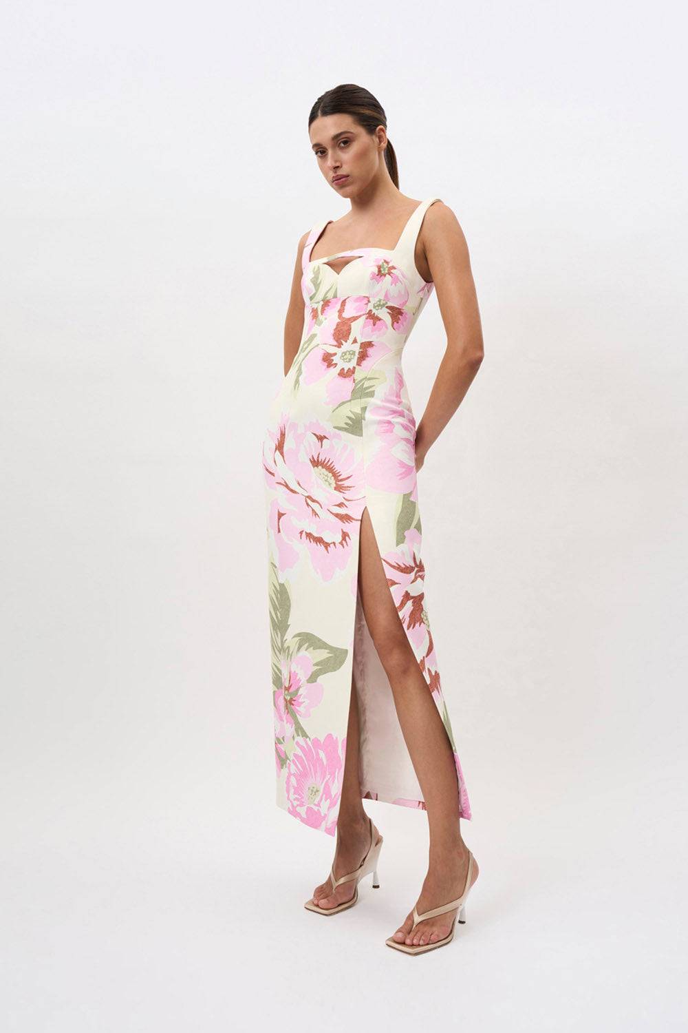 a woman in a By Johnny Edens Floral Square Peep Dress