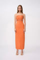 Woman wearing an orange dress with a white background