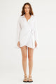 Woman wearing a white dress on a white background