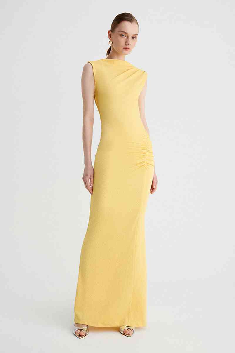 a woman in a yellow Suboo Vega Rouched Front Midi Dress in Butter