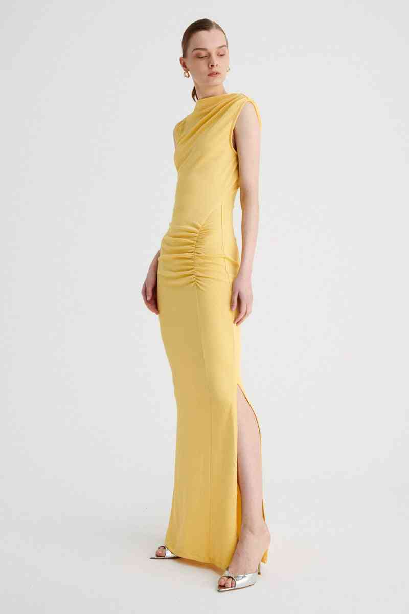 a woman in a yellow Suboo Vega Rouched Front Midi Dress in Butter