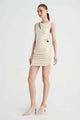 a woman in a Suboo Jacqui Twist Front Mini Dress and heels