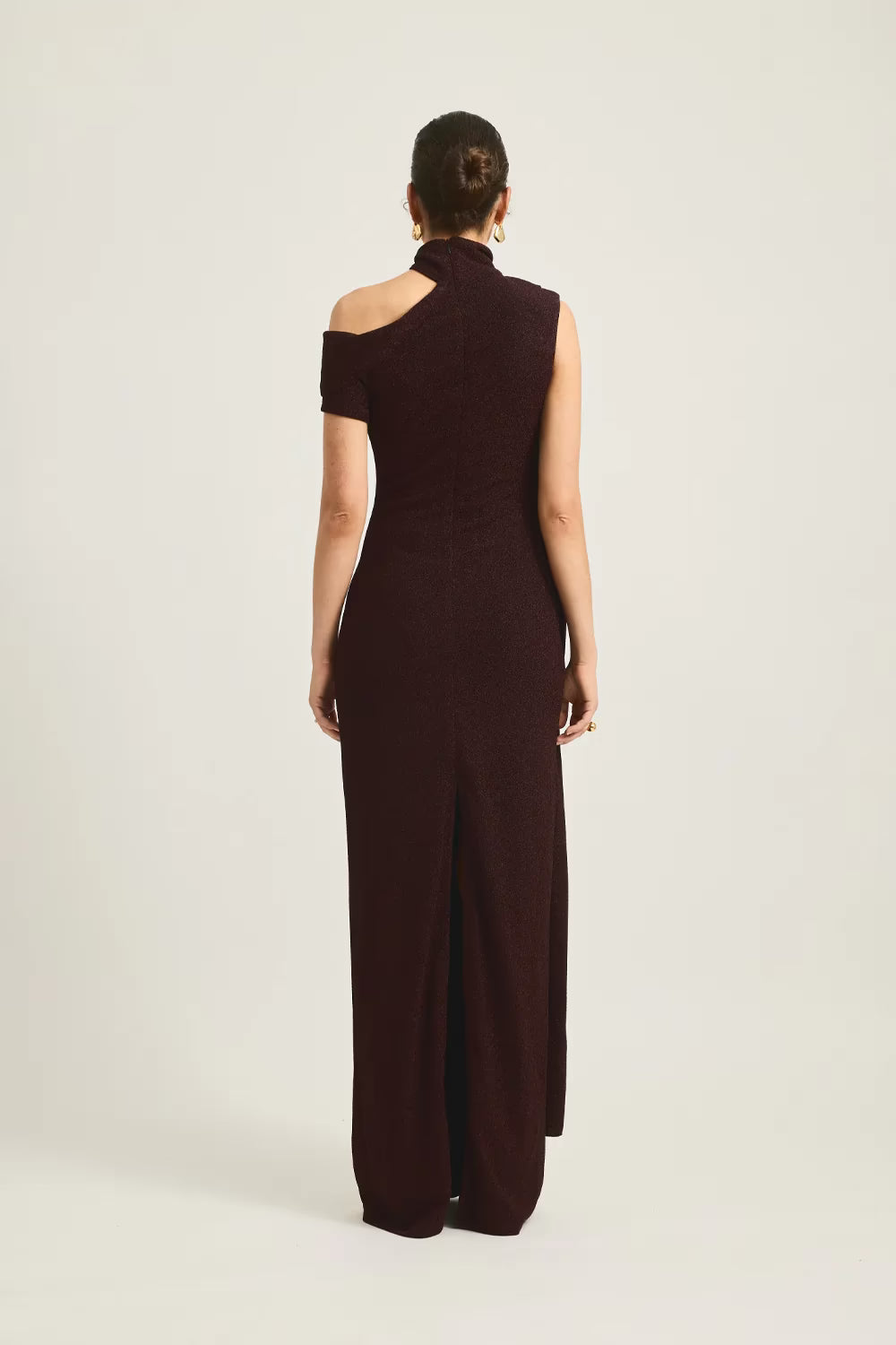 Izara dress in deep burgundy, featuring a one-shoulder design and a side slit, shown from the back.