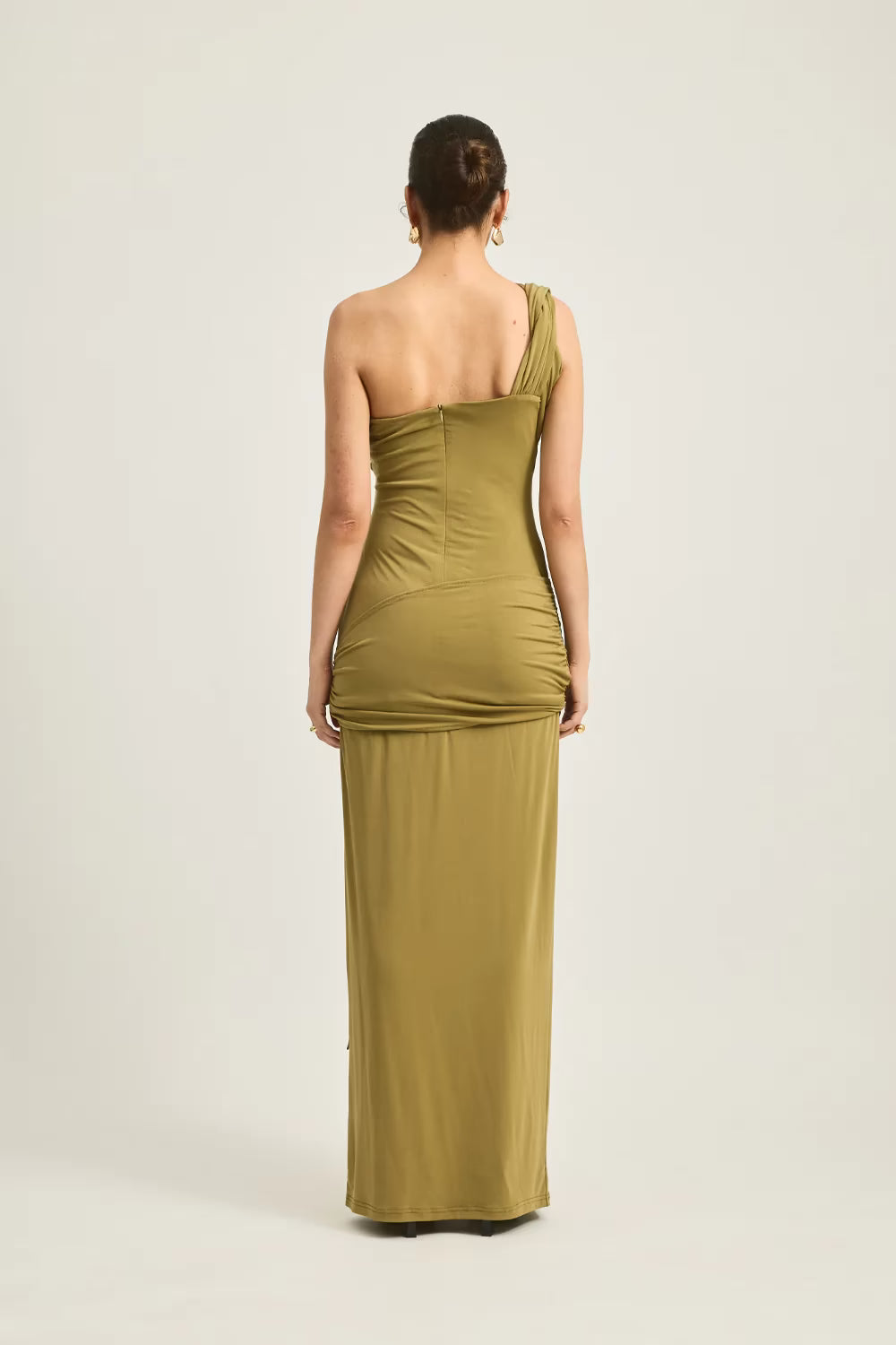 Maxi Atiyah dress in olive green, featuring a one-shoulder design and fitted silhouette, shown from the back.