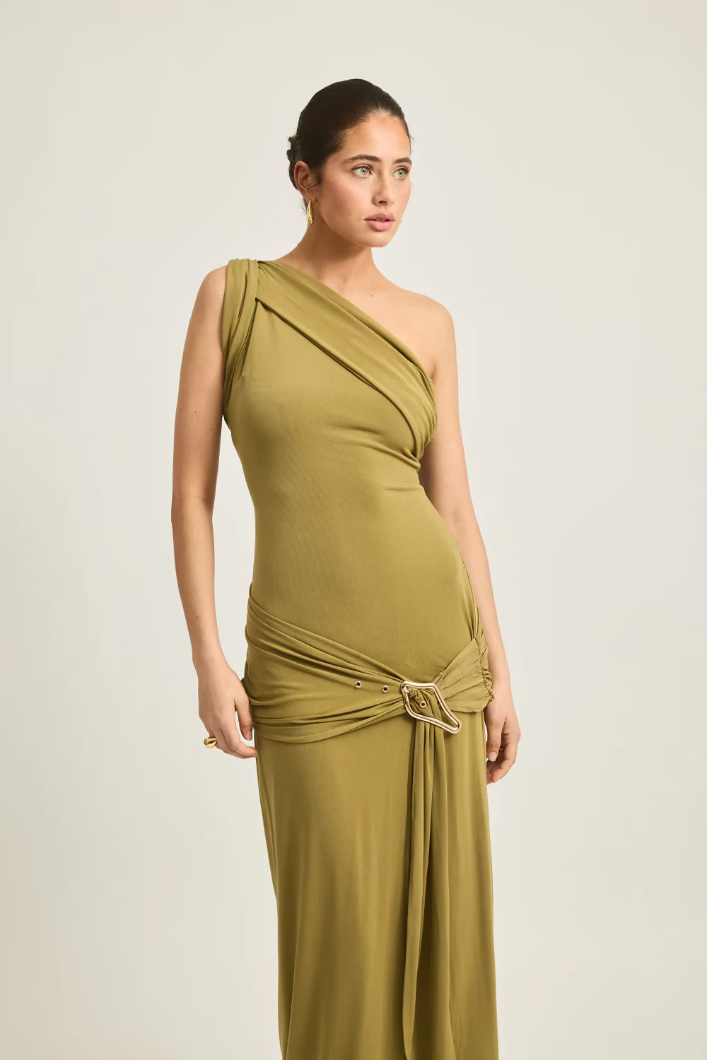 One-shoulder olive green maxi dress with a draped design and a decorative belt detail at the waist.
