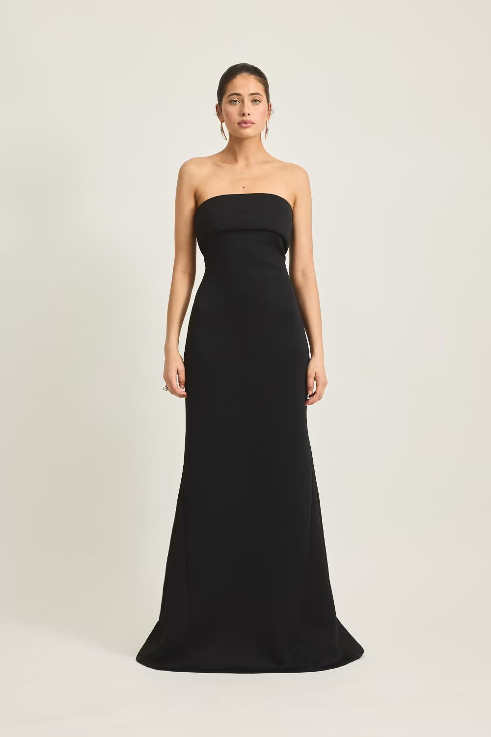 Stellan gown in black, strapless design, fitted silhouette, worn by a model against a neutral background.