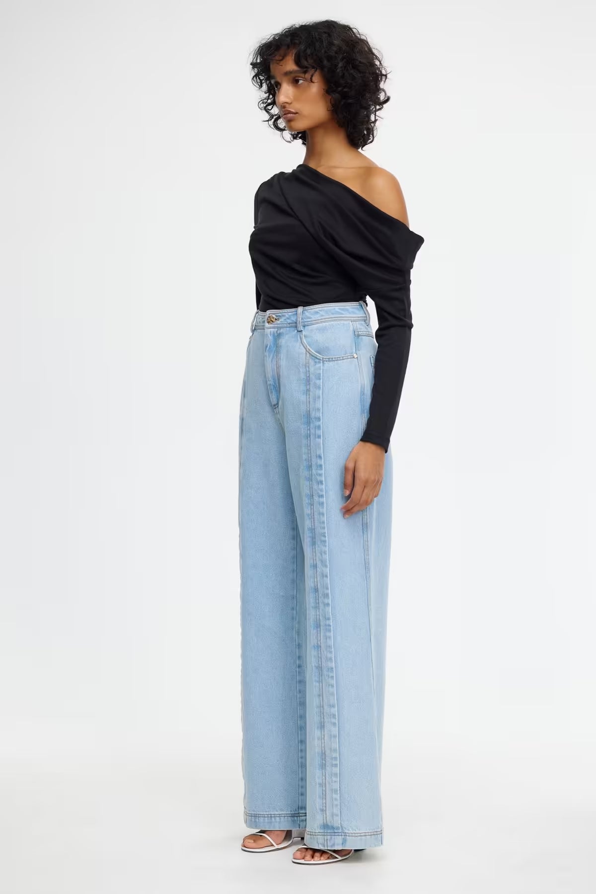 Midwash wide-leg denim jeans, side profile