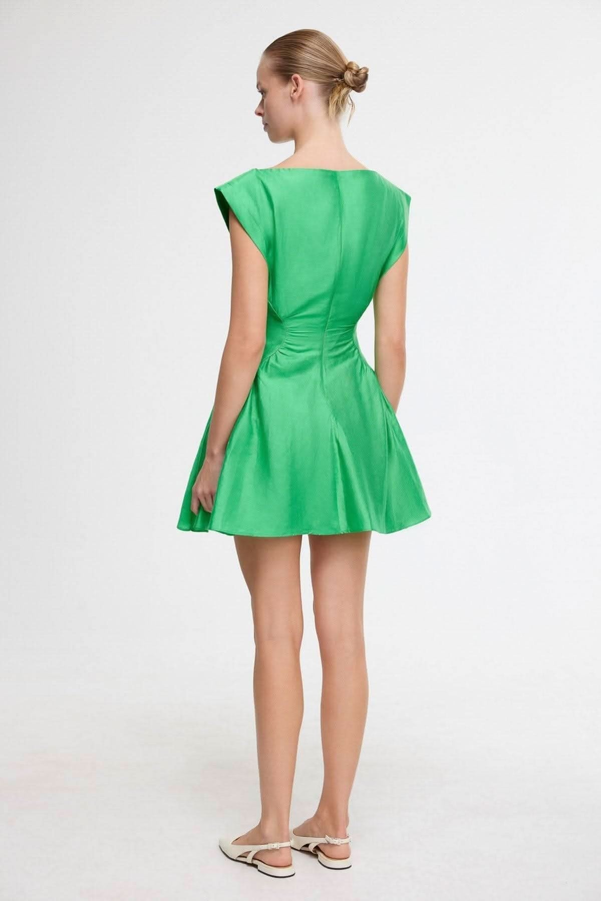 Green mini dress back view with gathered waist and short cap sleeves