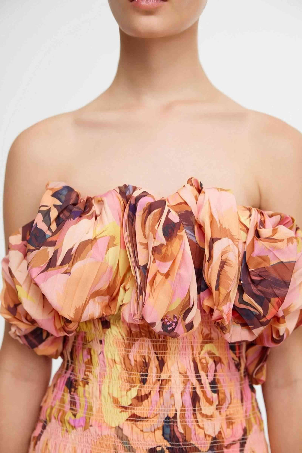 Close-up floral off-shoulder ruffled neckline with gathered elastic bodice