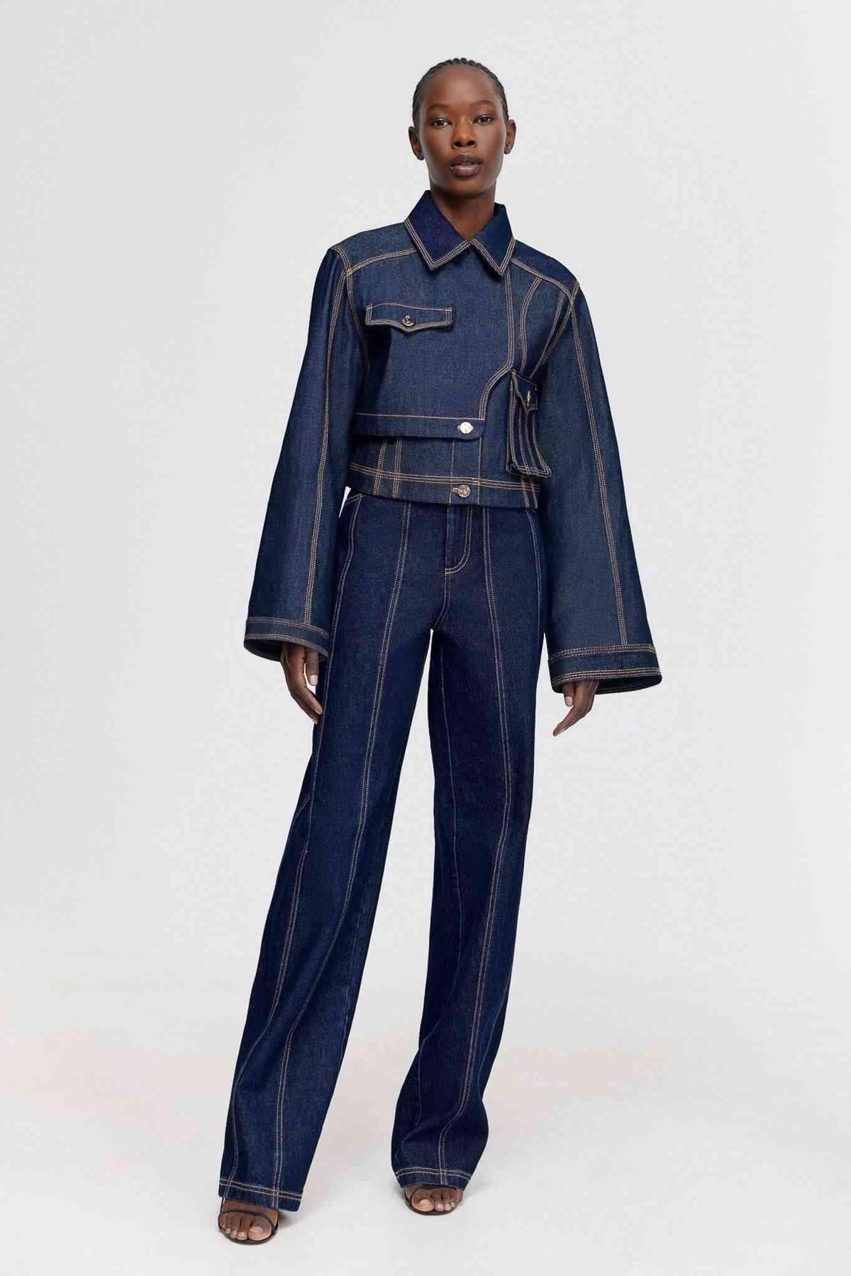 Dark indigo denim jeans with button front, wide legs, patch pockets