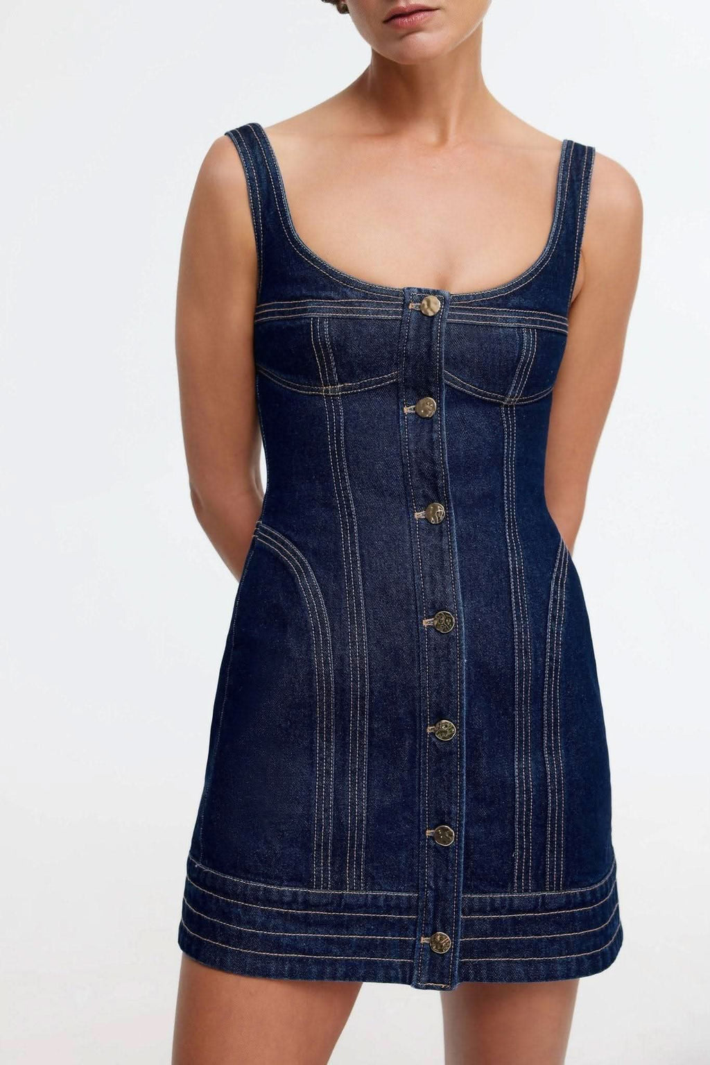 Dark indigo denim mini dress with sleeveless square neck and chest pockets
