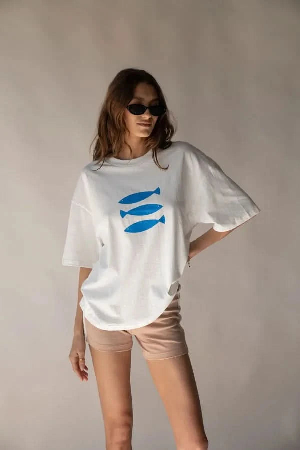 White crew-neck tee with blue fish graphic, short sleeves; straight hem.