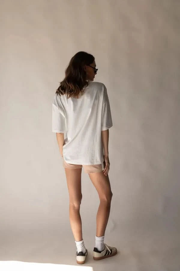 White crew-neck tee with short sleeves, back view; blue fish graphic not visible.