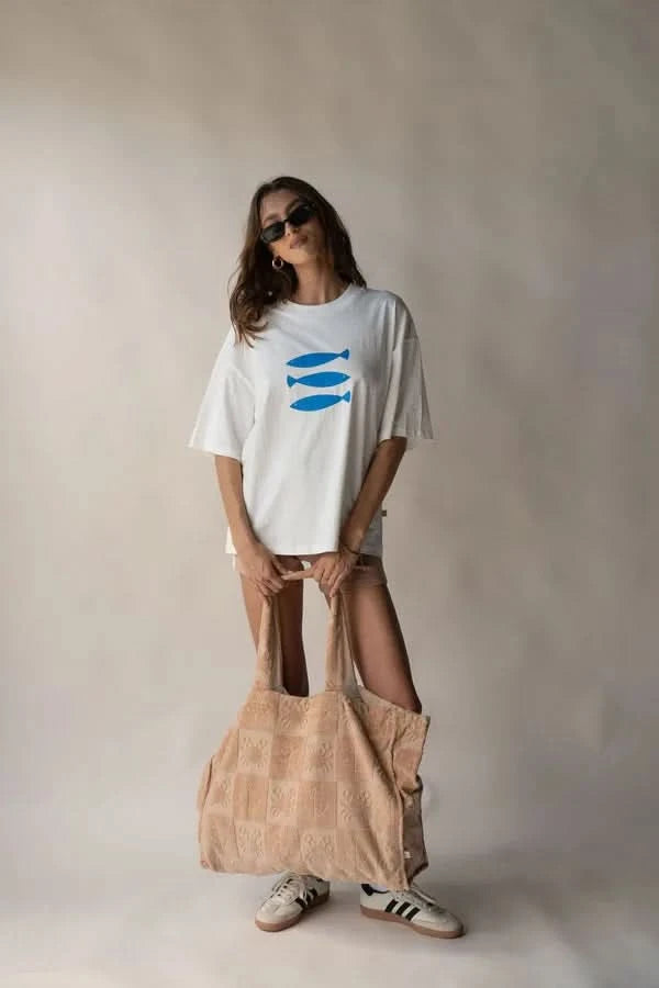 White crew-neck tee with blue fish graphic, short sleeves; front view.