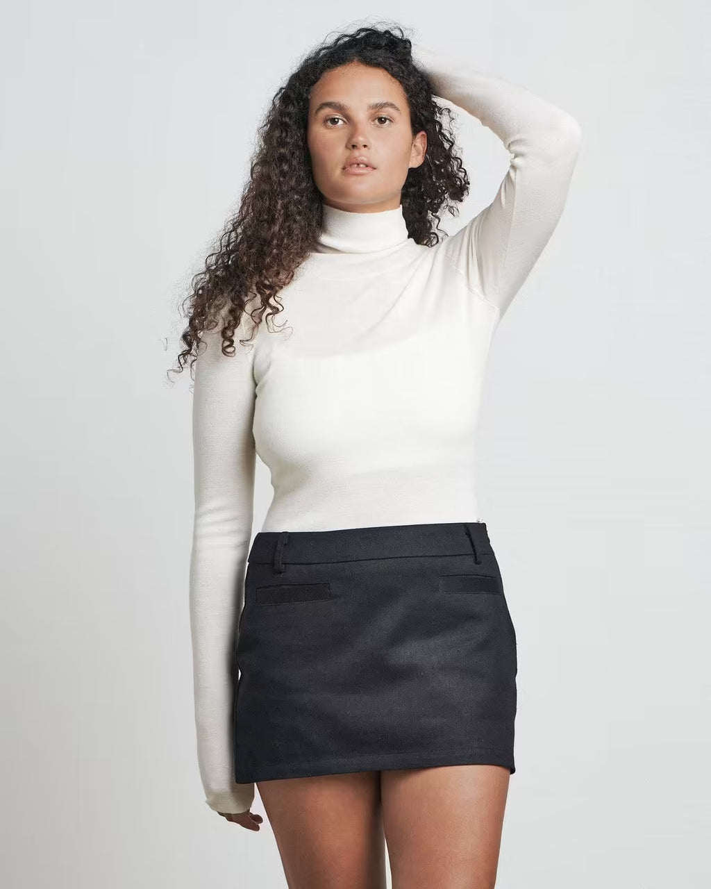 Black mini skirt with front button and straight hem