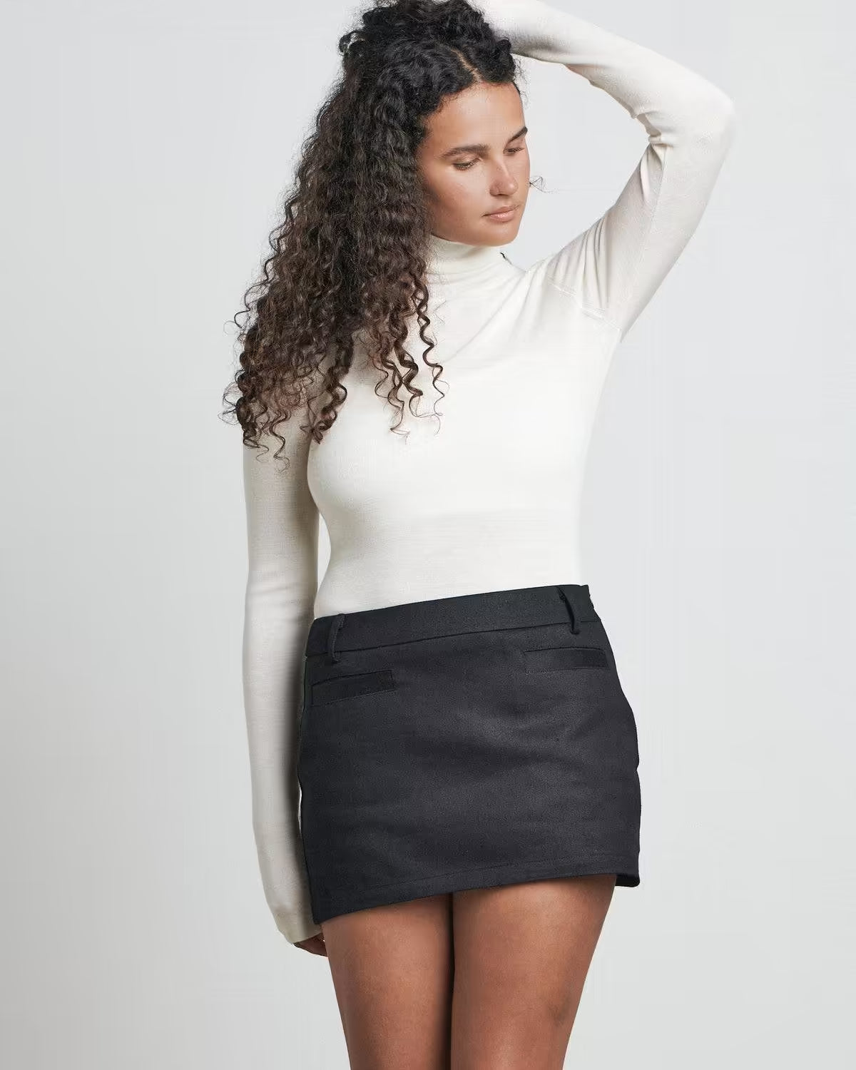 Black mini skirt with buttoned waistband and tailored seams