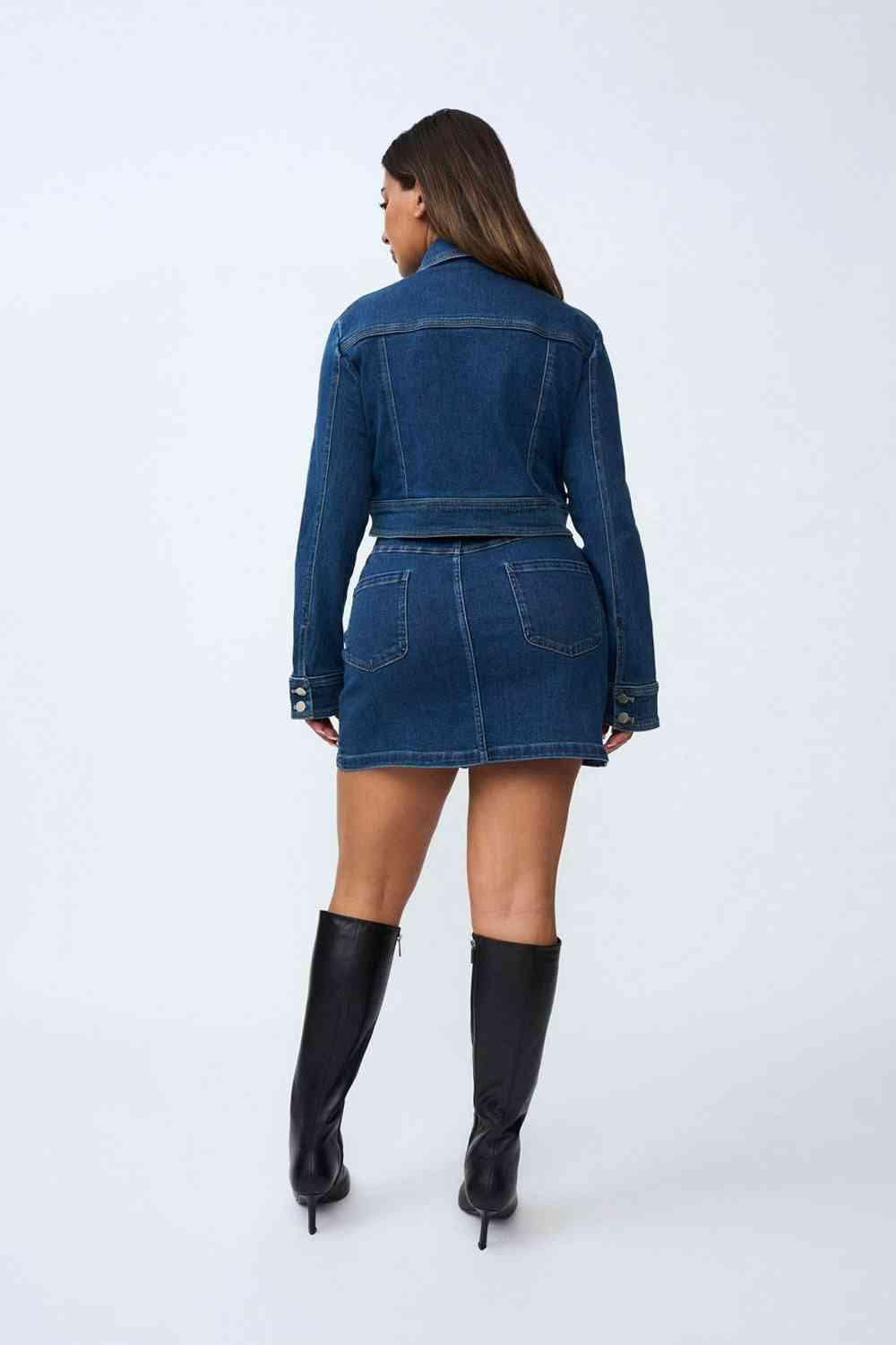 Indigo denim crop jacket, back view with center back button detail and flap pockets