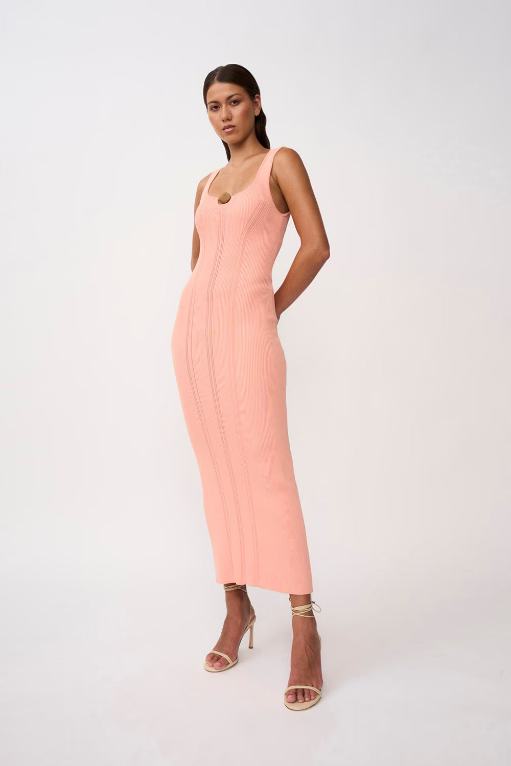 Peach ribbed knit midi dress with tan bead detail at the neckline
