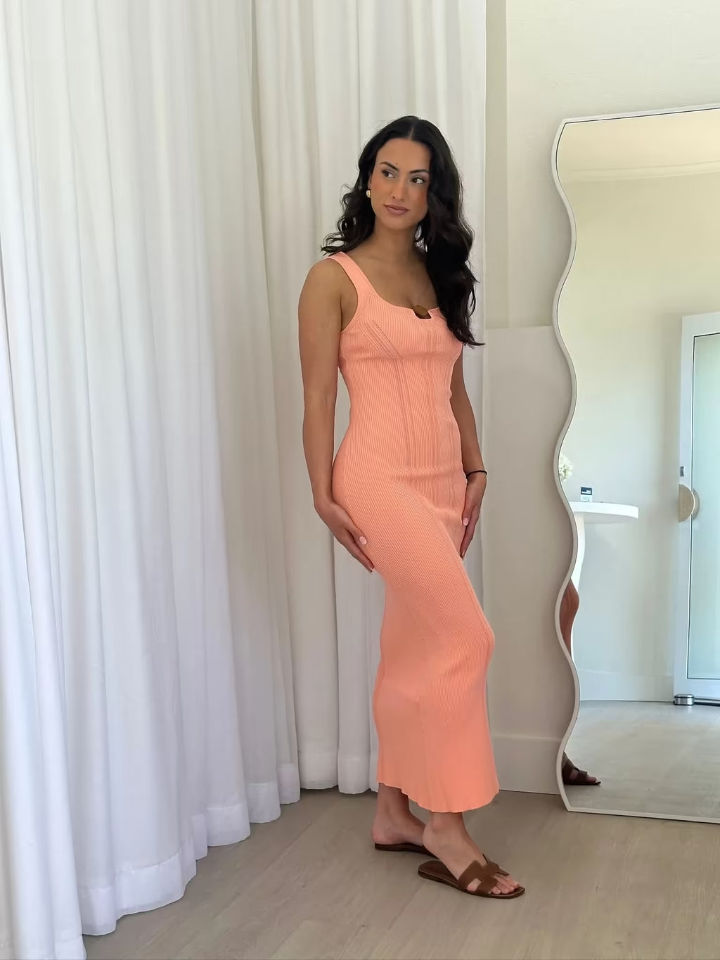 Peach ribbed knit midi dress, side view with sleeveless scoop neckline