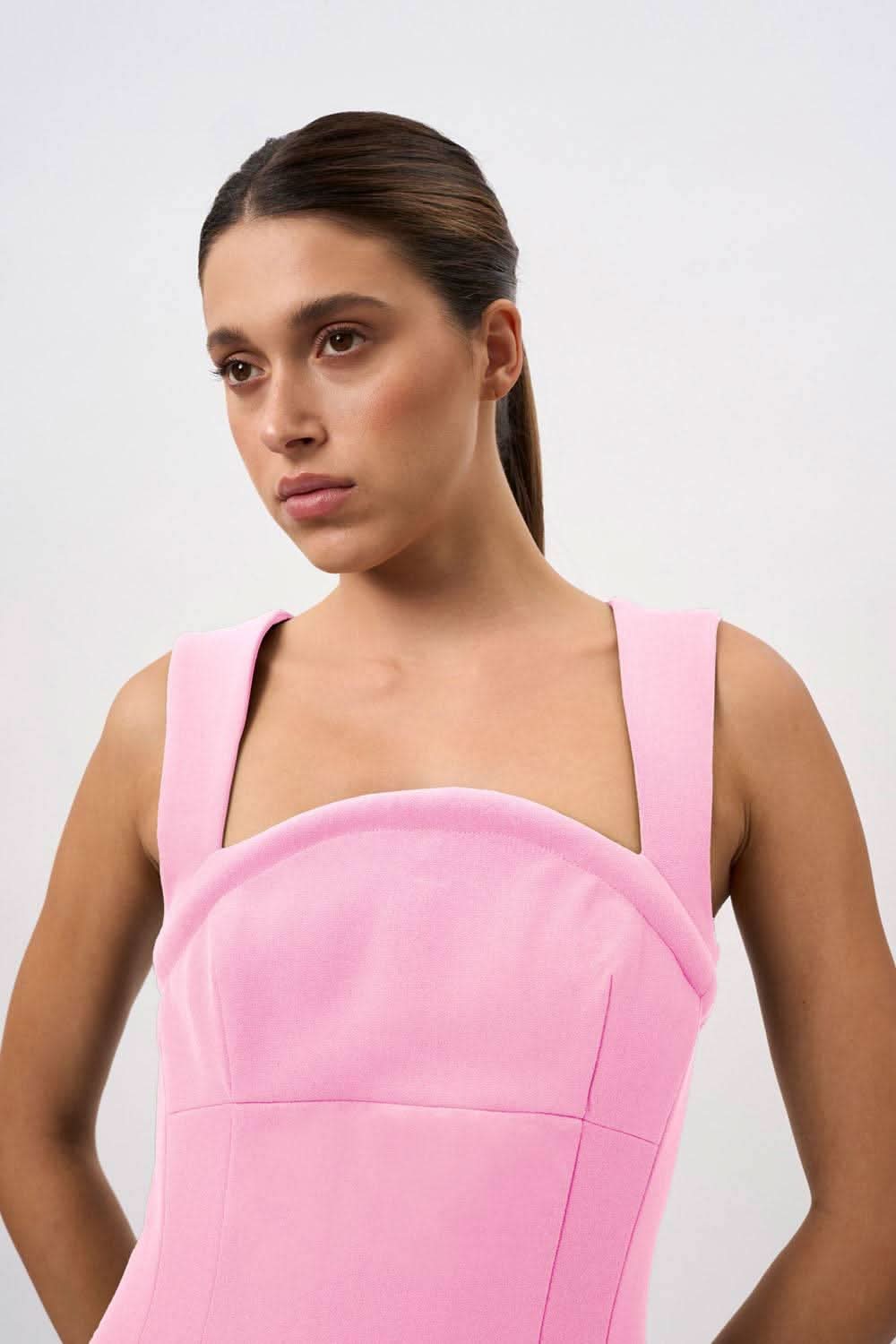 Pink sleeveless midi dress close-up: square neckline, thick straps, curved seams