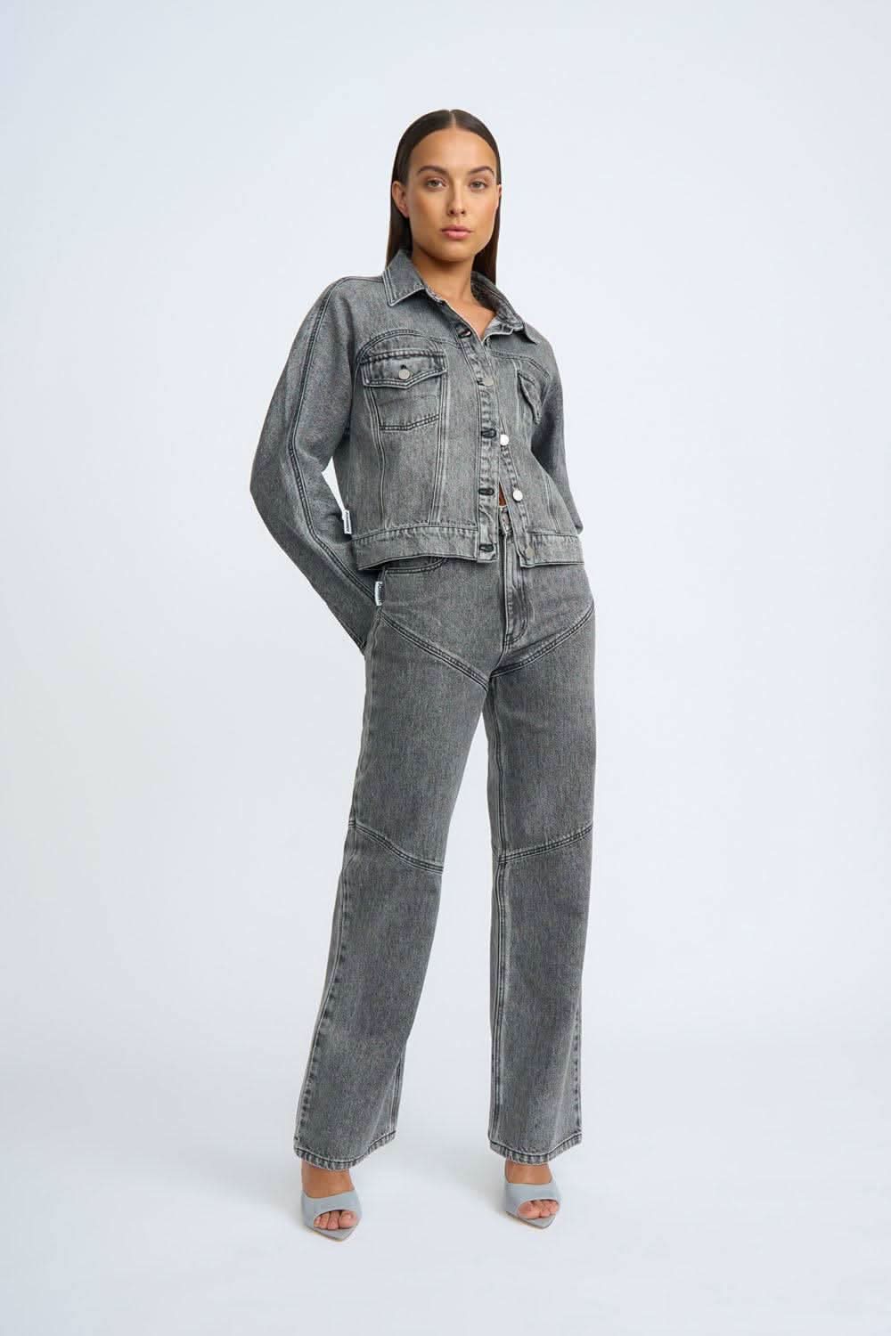 Grey stone-wash denim jeans with front button closure, belt loops, and wide-leg fit