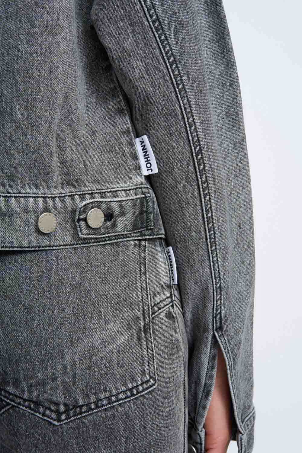 Grey stone-wash denim jacket sleeve and chest pocket with logo patch
