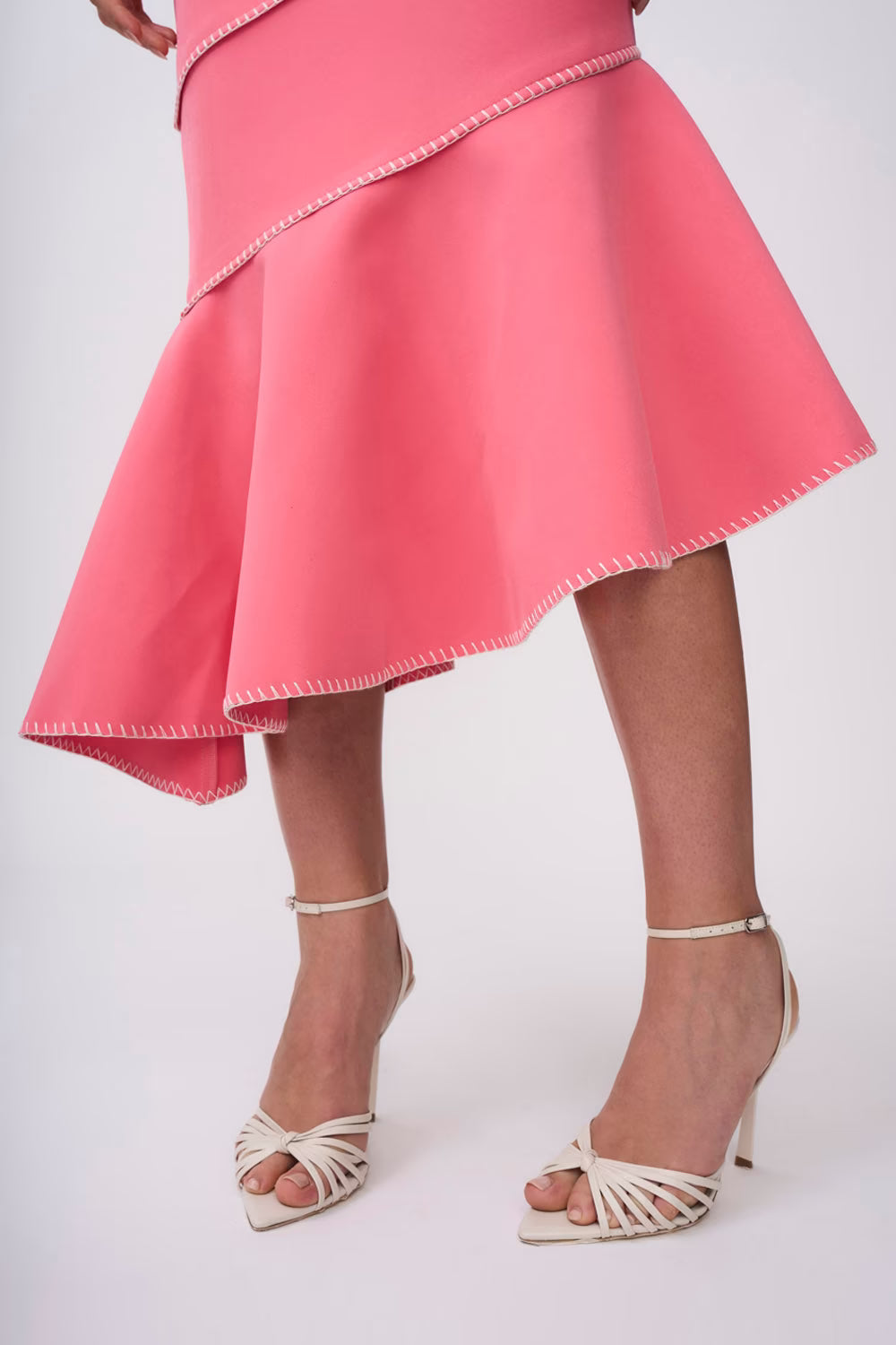 Pink midi dress hem detail with spiral seams and flared skirt