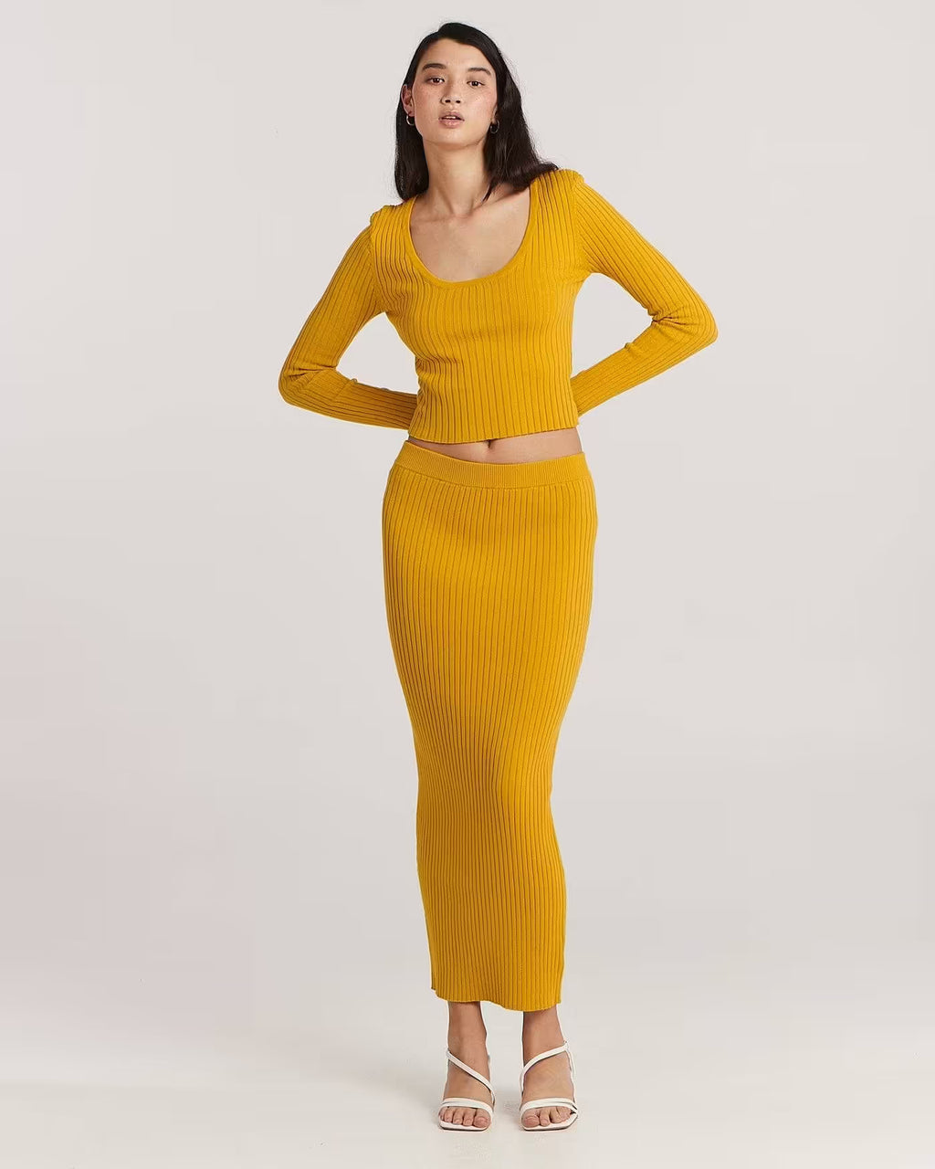 Golden ribbed long-sleeve scoop-neck top with fitted cropped silhouette
