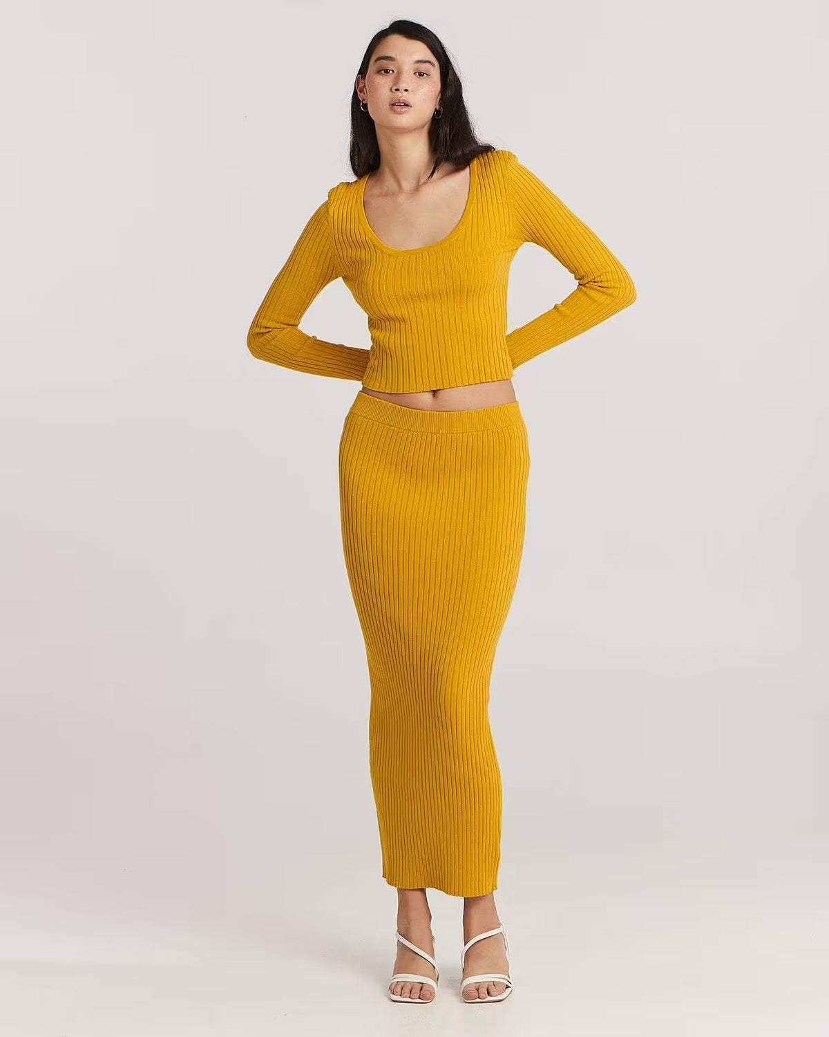 Golden ribbed long-sleeve scoop-neck top with fitted cropped silhouette