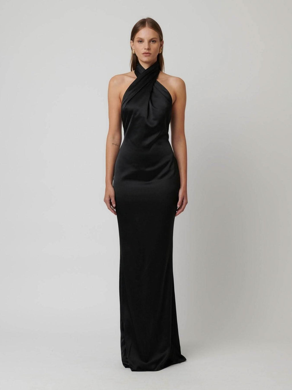 Black satin halter gown with draped cowl halter neck and long column skirt