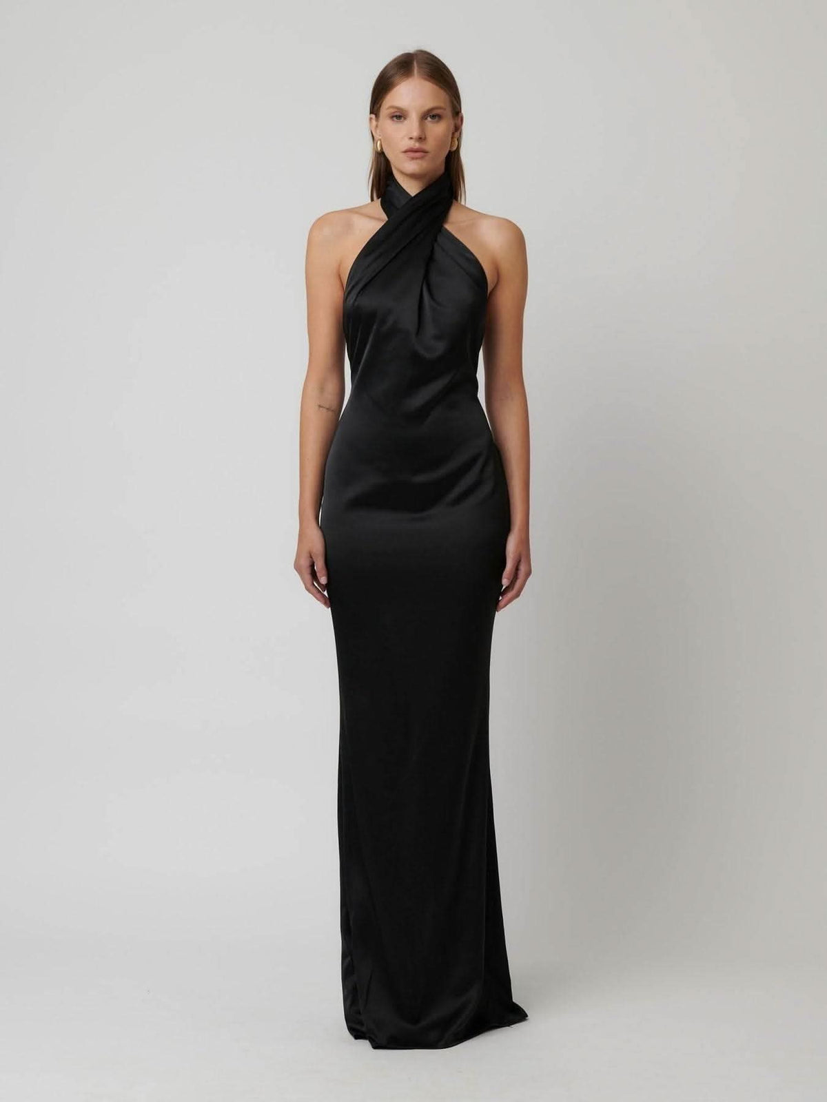 Black satin halter gown with draped cowl halter neck and long column skirt