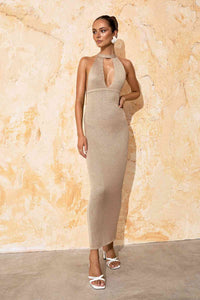 Thumbnail for a woman in a beige Flook the Label Amoria Dress standing in front of a wall