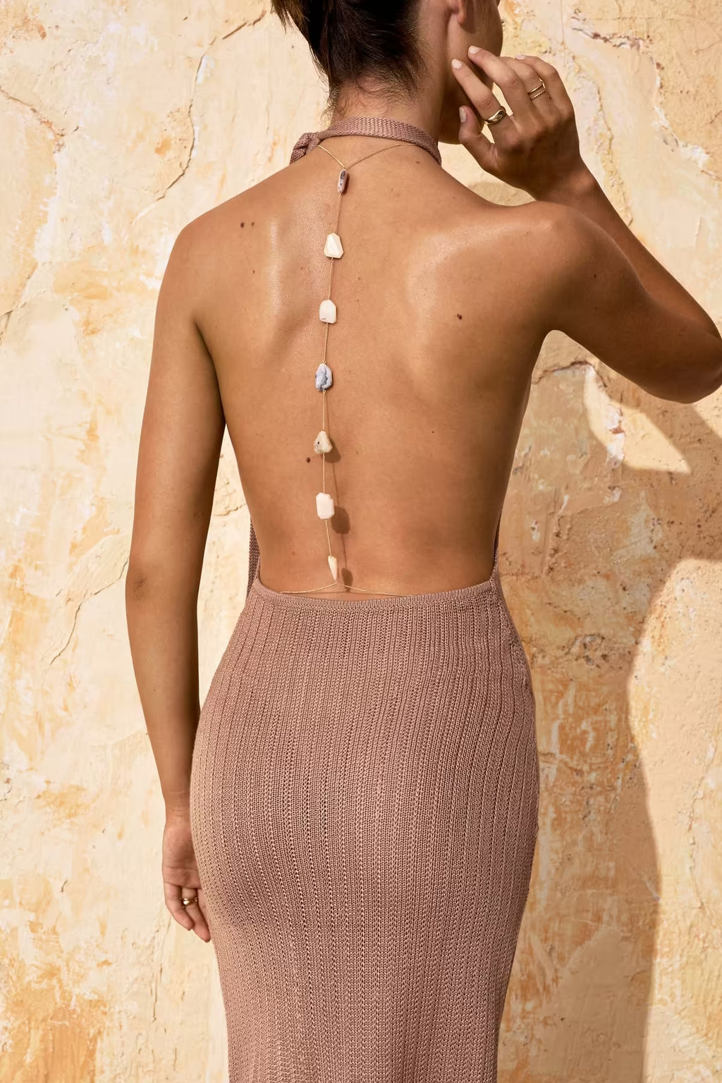 Back view of taupe sleeveless maxi dress with long strap button closure