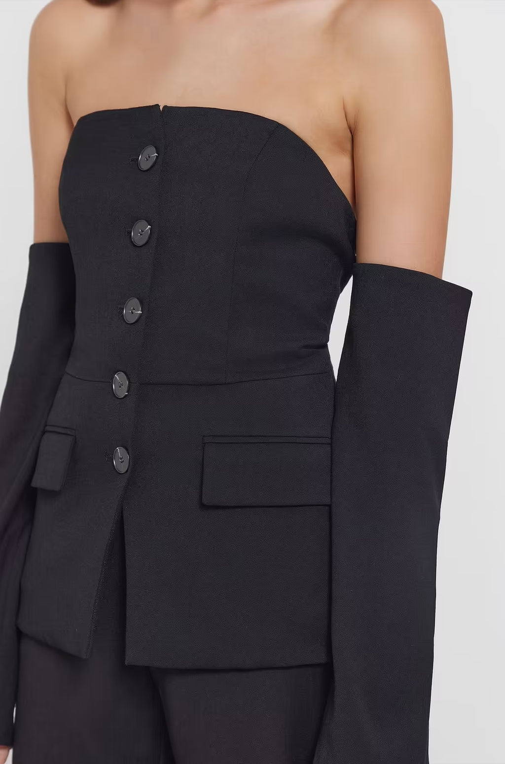 Black strapless top with buttoned bodice and rectangular patch pockets