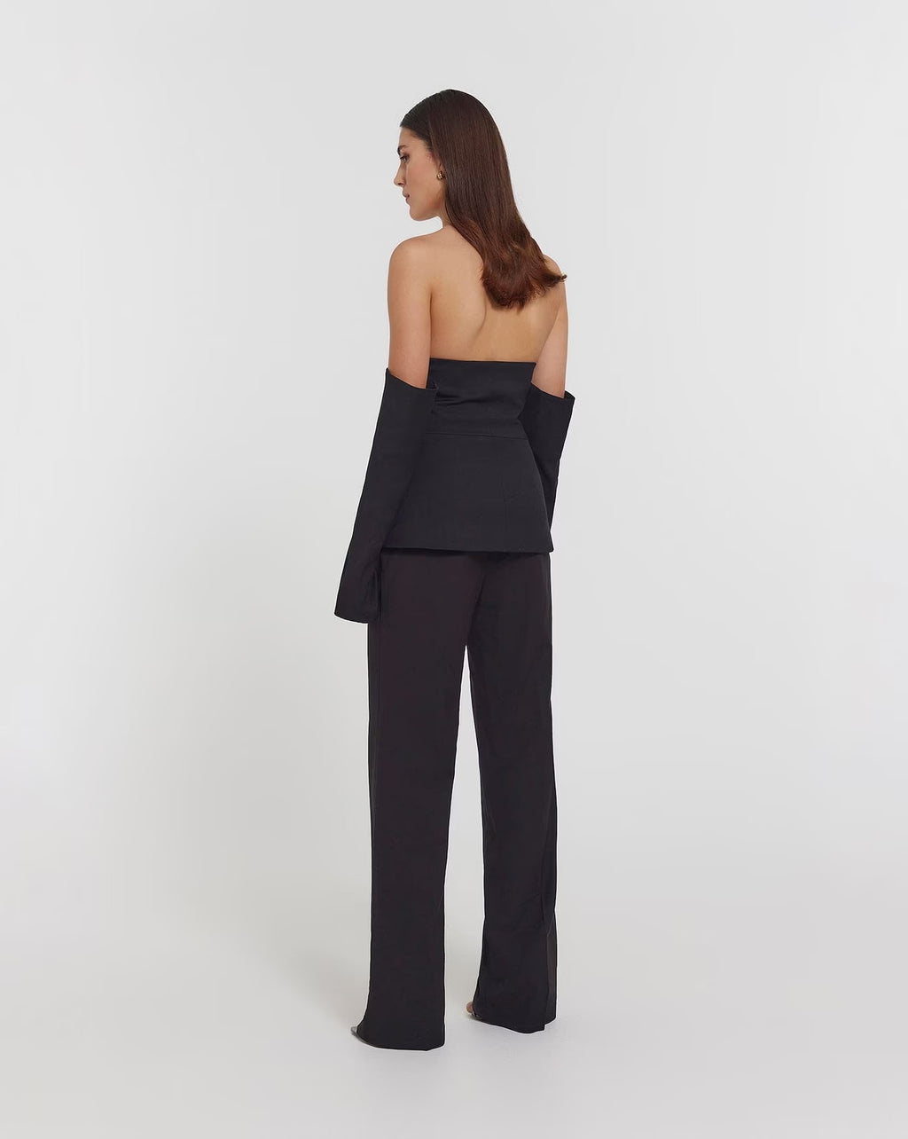 Black strapless top with draped off-shoulder back and button placket