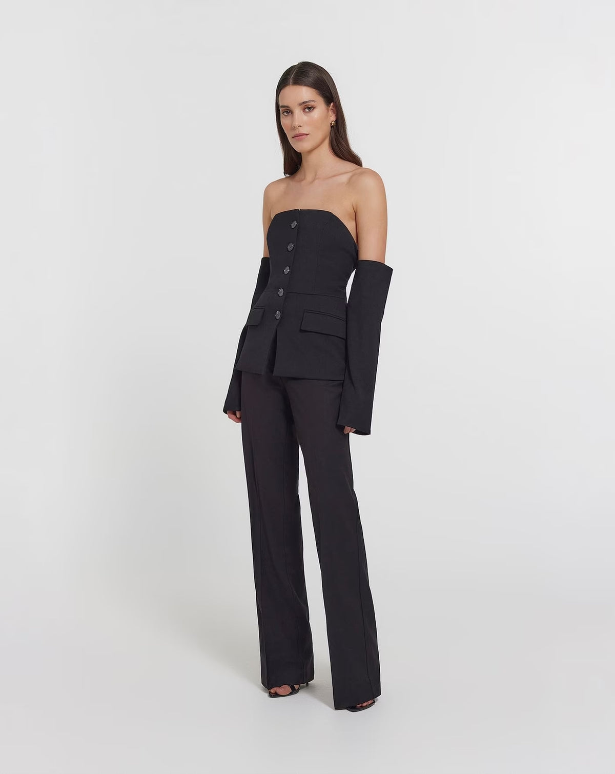 Black strapless top with button-front detail and long off-shoulder sleeves