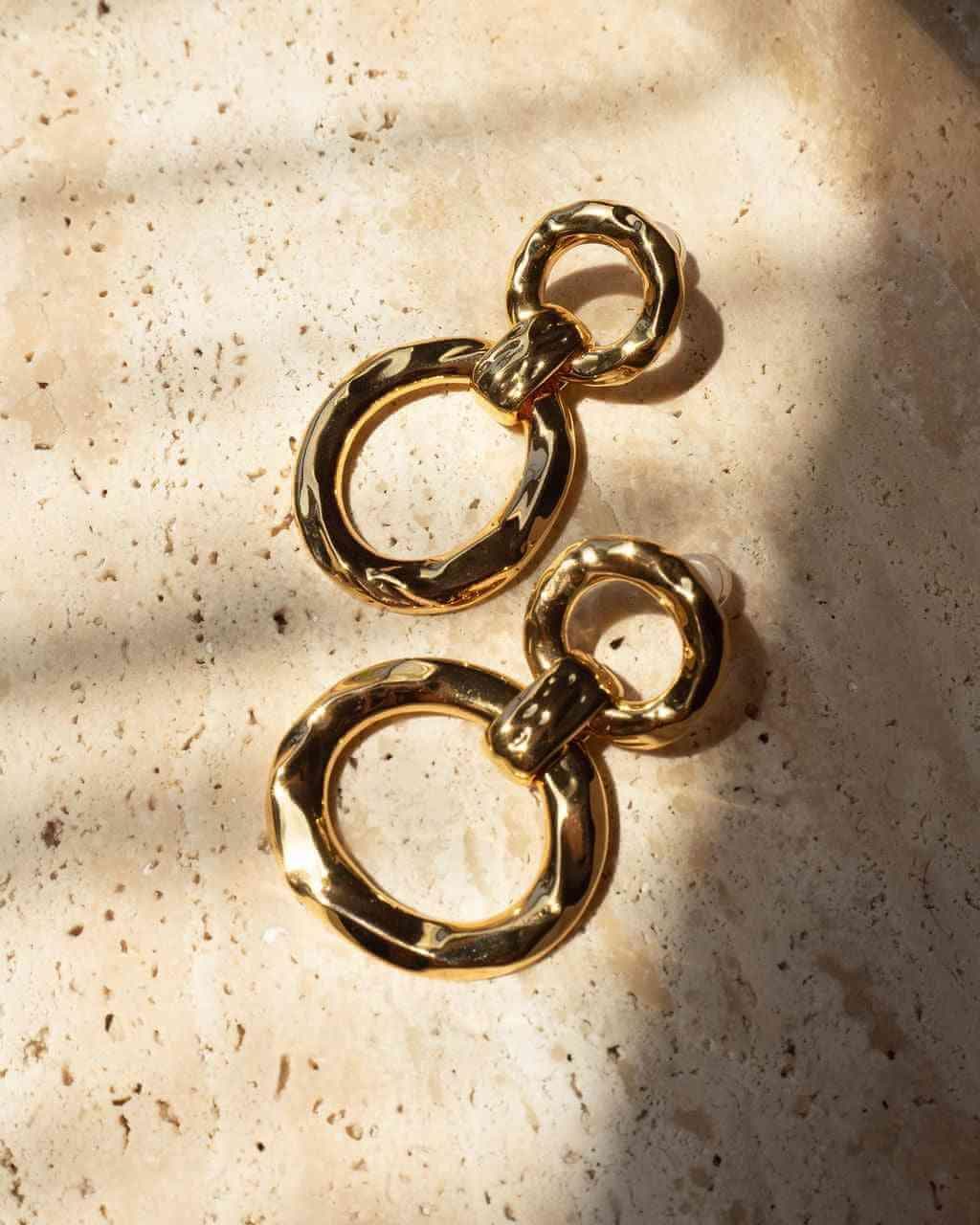 Gold hammered loop hoop earrings with two circular rings and a small top connector