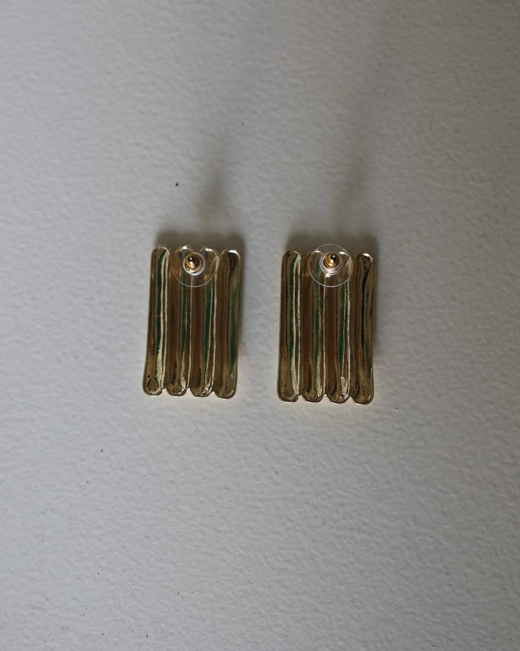Gold ridged half-hoop earrings with vertical grooves, small pair