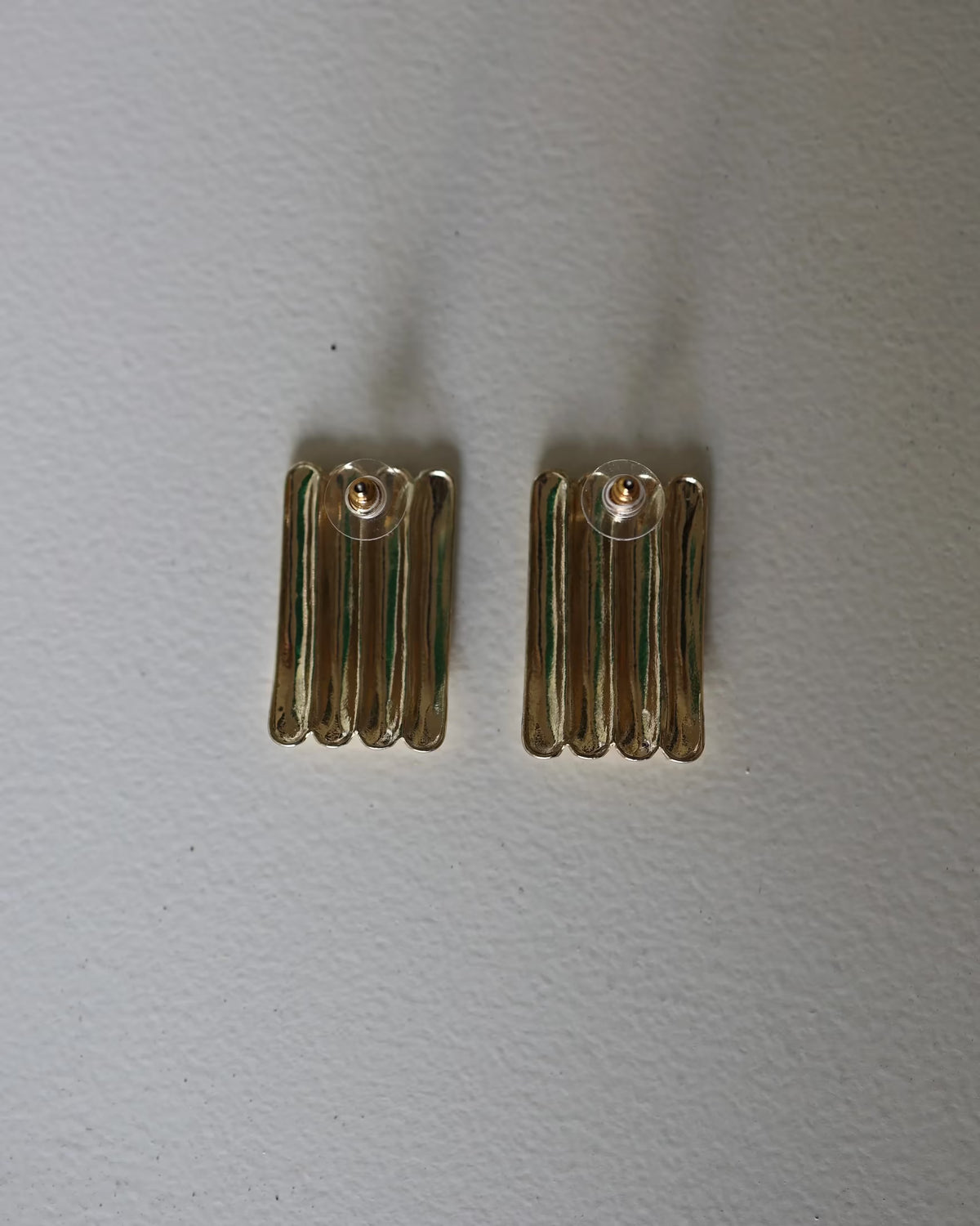 Gold ridged half-hoop earrings with vertical grooves, small pair