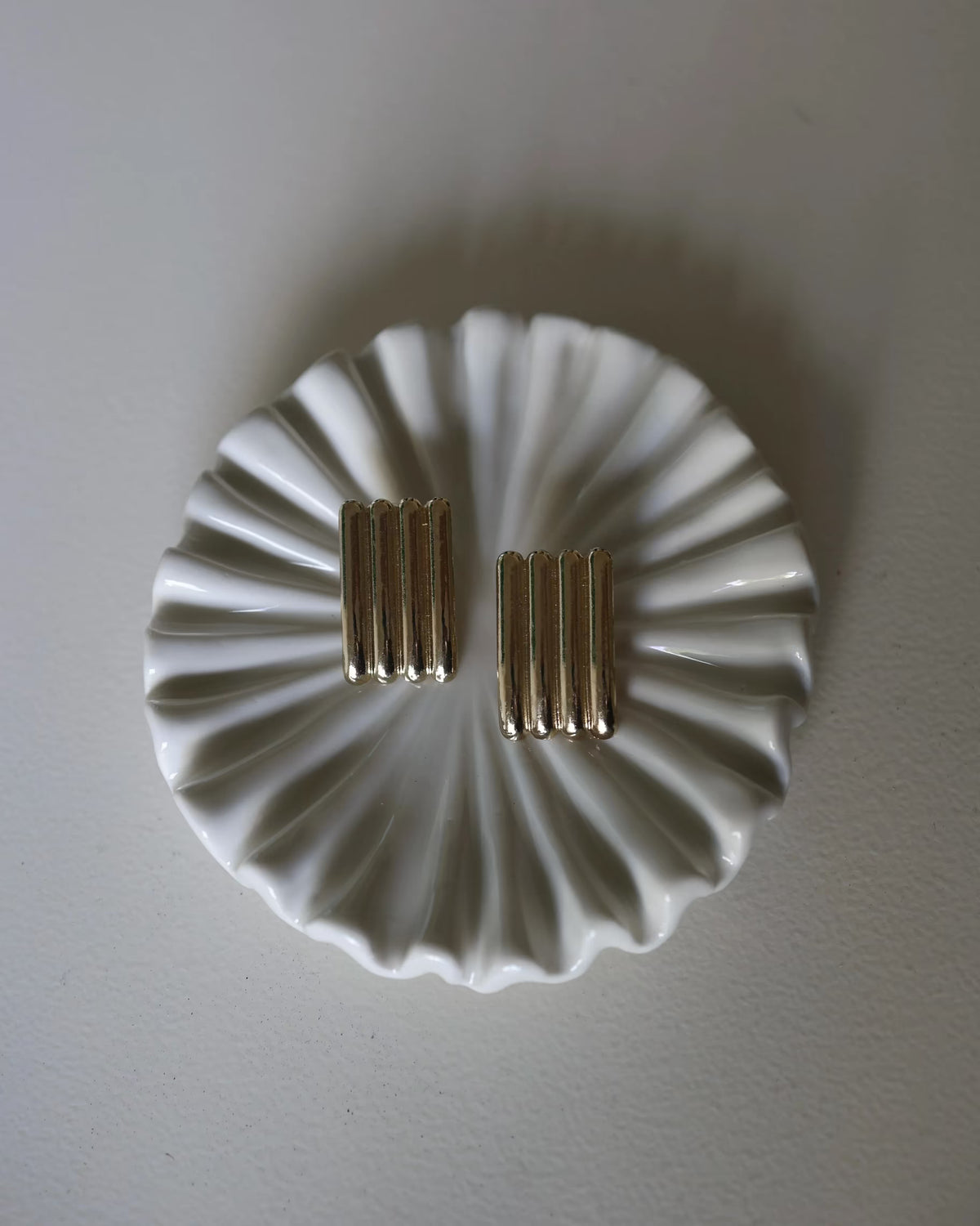 Gold ridged half-hoop earrings with vertical grooves, two earrings shown