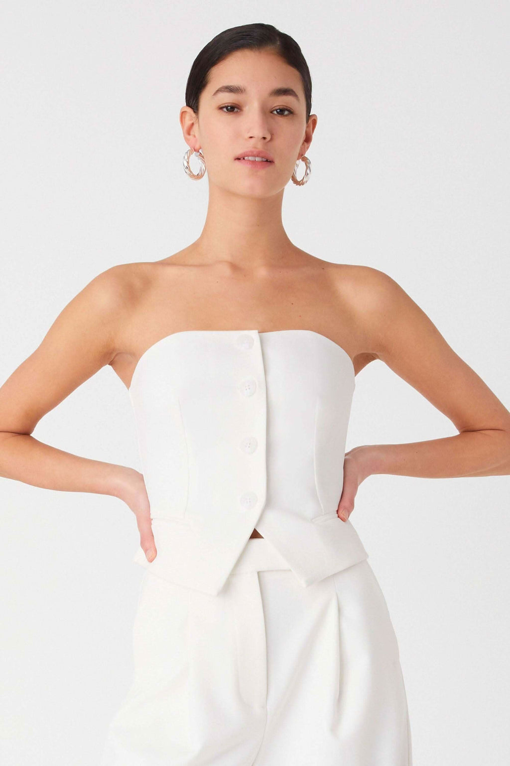 Ivory strapless top with peplum ruffle and front detail; wide-leg trousers outfit